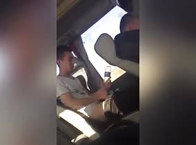 Asian lad jerks into empty water bottle on the bus