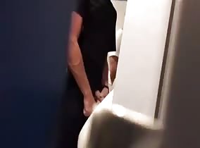 Peeping on lucky boy getting a handjob from a stranger at the urinal