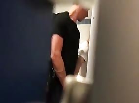 Watching the action in a cruisey bathroom via a peep hole