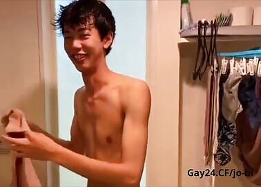 Asian with an erect dick tries on tight panties