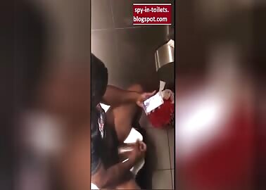 Spying a black wanker with a big dick in the Toilet