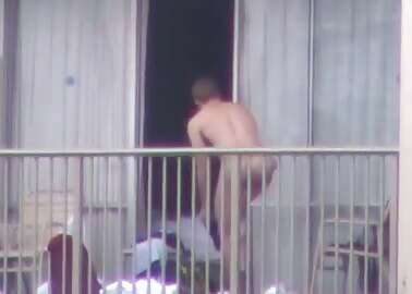 Swimmer strips naked on his balcony