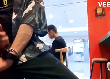 Asian lad jerking off and cumming on the food-court